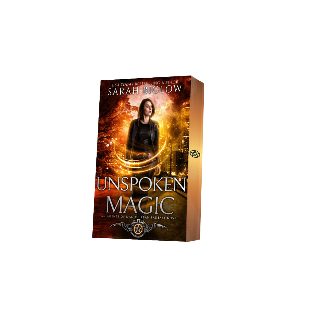 Paperback of Unspoken Magic with decorative edges by Sarah Biglow on a white background.